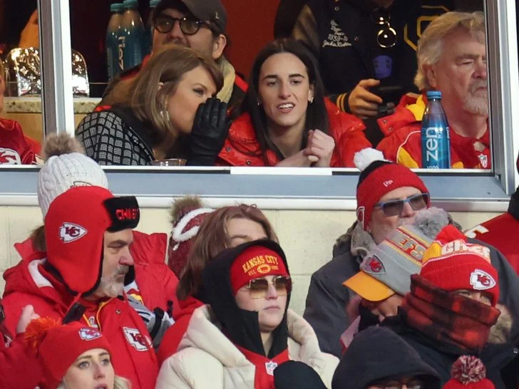 Taylor Swift talks with Caitlin Clark of the Indiana Fever during the second half in the AFC Divisional Playoff between the Houston Texans and the Kansas City Chiefs at GEHA Field at Arrowhead Stadium on January 18, 2025 in Kansas City, Missouri.